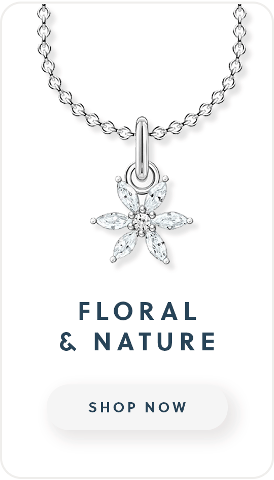 A silver necklace with a cubic zirconia flower pendant with caption floral and nature shop now