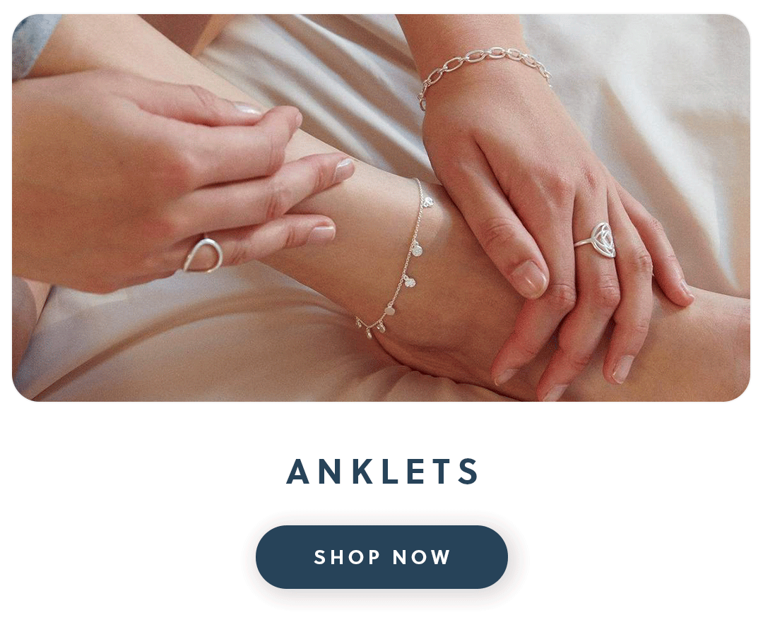 A close up of a woman's anklet with a gold Daisy London anklet with text anklets shop now