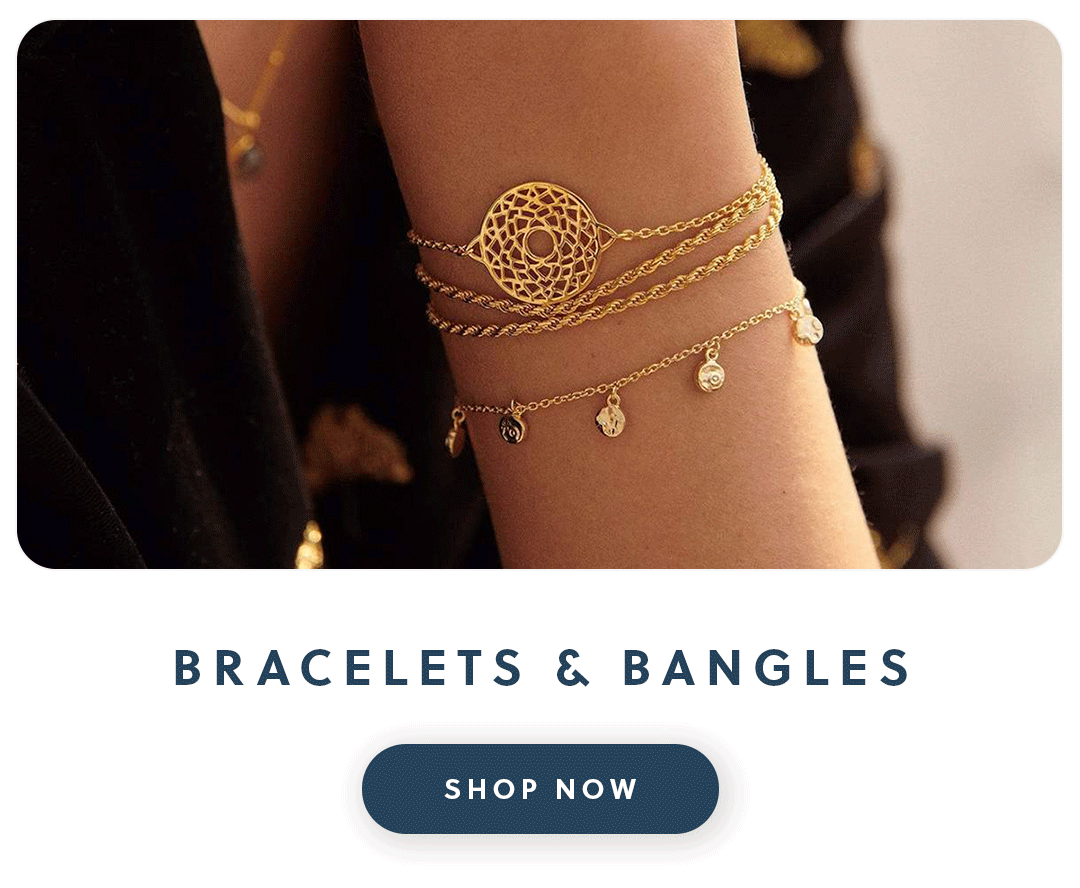 A close up of a woman's hand wearing gold Daisy London jewellery with text bracelets and bangles shop now