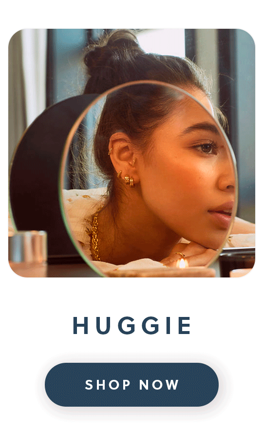 A close up of Daisy London Huggie earrings with text huggie shop now