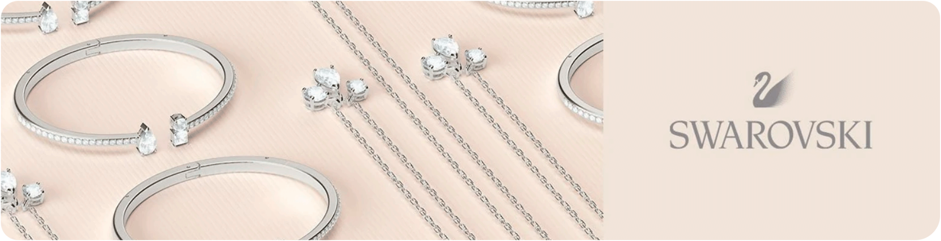 A collection of silver Swarovski jewellery including bracelets and necklaces with the Swarovski swan logo