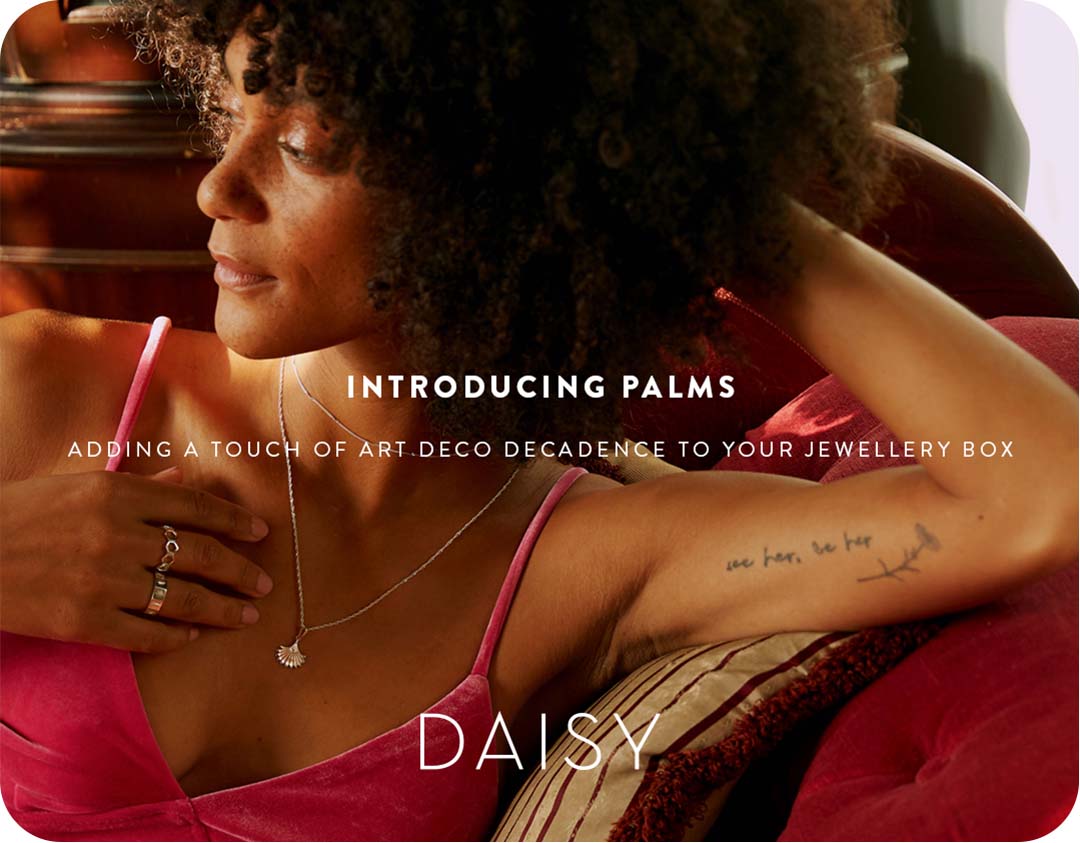 A woman wearing Daisy London Palms collection necklace and rings