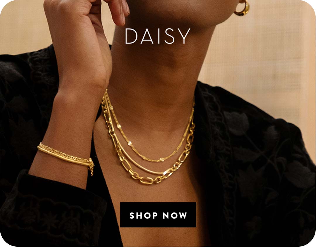 A woman wearing Daisy London Chains collection necklaces
