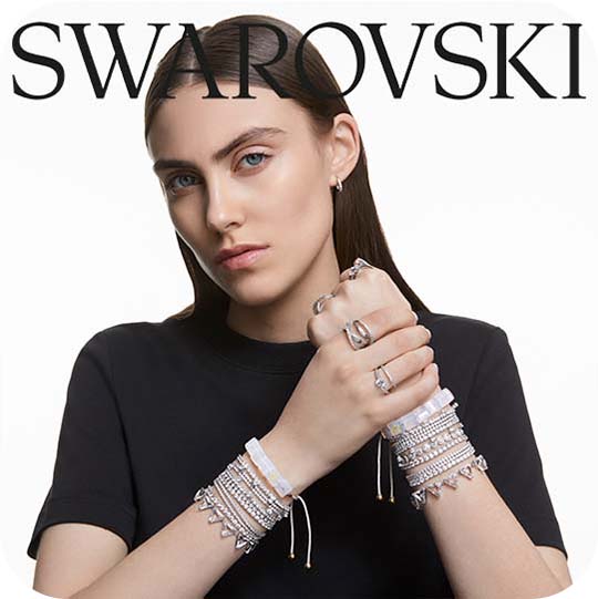 Woman wearing black top & several silver Swarovski bracelets