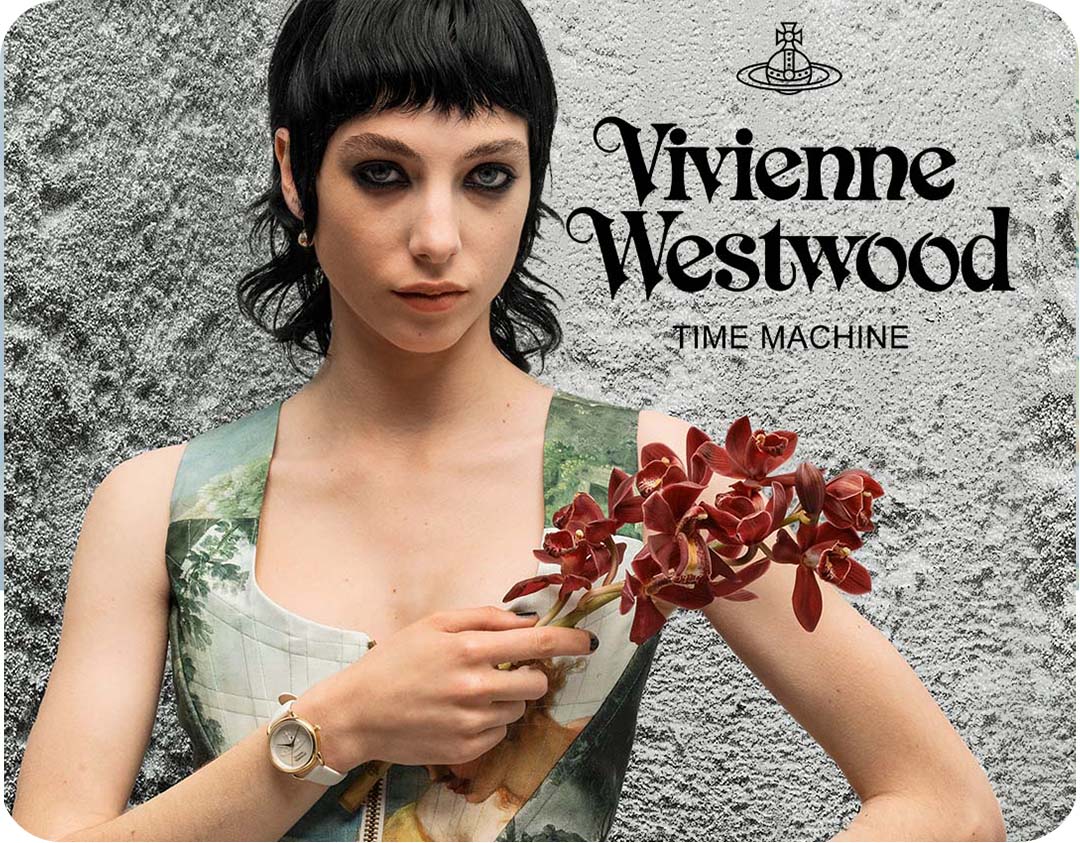A body shot of a woman wearing a Vivienne Westwood watch holding orchid